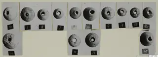 Mounted photographs of fourteen perforated round stone objects from Nitovikla T.I, with number labels