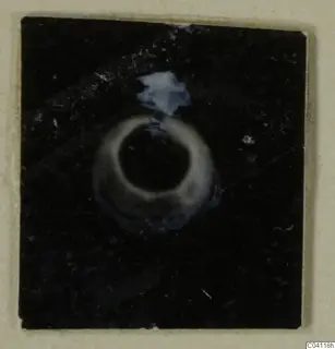 Small ring-shaped object against a dark background, Amathus tomb find