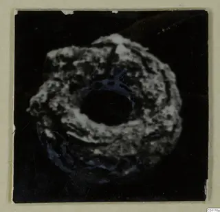 Ring-shaped find with a large central hole, from Amathus, photographed against black