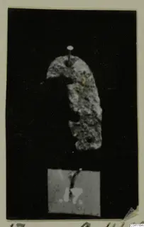 Irregular curved fragment of a find from Amathus T. 2-26, pinned against a black background