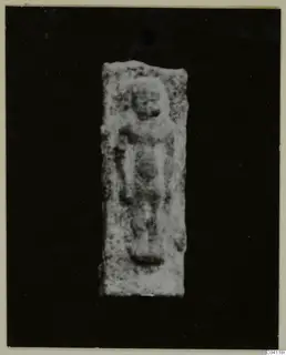 Rectangular plaque with a raised relief of a standing figure, photographed against a black background, from Vouni