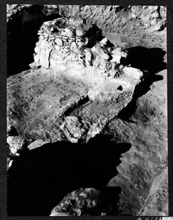Excavation at Cholades Temples A-B at Soli, with a stone rubble wall and a stepped edge in the trench
