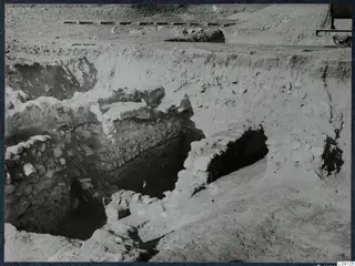Excavation trench at Cholades, Soli, with stone walls and a narrow rail track running along the top of the cutting