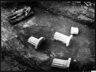 Excavated floor of Room XLV at Cholades, Soli, with fluted stone column pieces and a carved block in situ