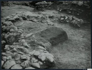 Excavated stone walls and a stone-edged offering pit at altar 154 in Room XLIII A, Cholades, Soli