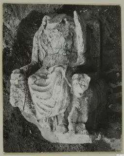 Stone sculpture of a draped figure from Soli, broken and lying in excavated soil