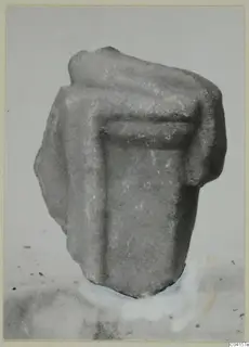 Fragment of a marble sculpture with a projecting upper part and a recessed panel in the centre.