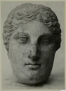 Marble head of a figure with wavy hair, seen from the front