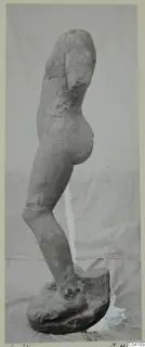 Stone statue of a standing figure in side view, with head and arms missing, from Soli