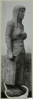 Stone statue of a standing figure from Soli, with scale-patterned upper garment, wide belt and carved skirt panels