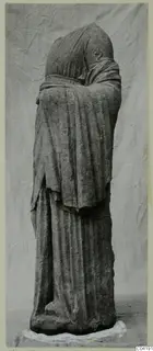 Standing stone statue of a draped figure from Soli, with head and shoulders wrapped in a heavy mantle.