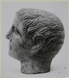 Stone male head with wavy hair, shown in profile, from Soli