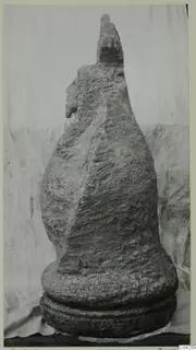 Weathered stone sculpture from Soli, with a head at the top and a face in profile on the left side.