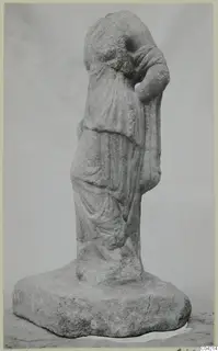 Marble statue of a draped standing figure with one arm raised to the head, on a rectangular base