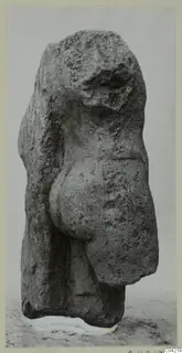 Weathered limestone sculpture from Mersinaki, an upright figure with a pitted, eroded surface