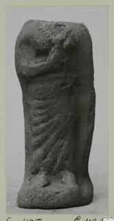 Terracotta figurine of a standing draped figure, head and upper body broken away, one arm bent across the body.