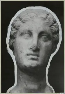 Marble sculpture of a head with curled hair, from the Soli finds, shown against a dark background