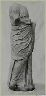 Stone statue of a standing draped figure from Soli, with the mantle pulled up over the head and body.