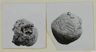 Two small rounded objects from Milia, one with incised chevron lines, shown in two prints mounted side by side