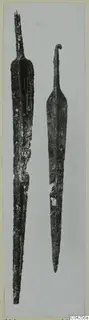 Two metal blades, one with a curled hook at the top; find from Milia