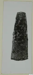 Corroded metal blade with a tapering form, from Milia, shown alone against a pale background.