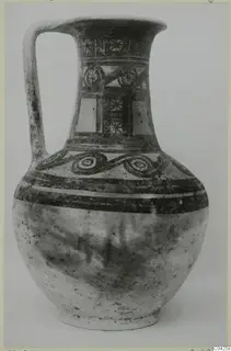 Painted jug with a strap handle and banded decoration, from Milia.