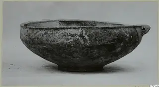 Pottery bowl with a small pierced handle, from Milia