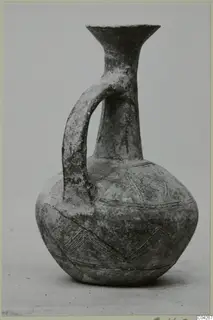 Pottery jug with a single strap handle and incised chevron bands, from Milia