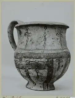 Jug with a single loop handle and dark painted bands on a pale slip, from Milia