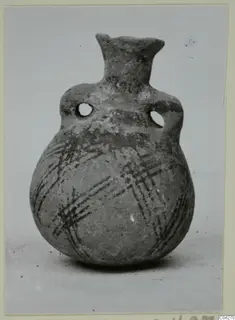 Round-bodied jug with two pierced lug handles and crossed dark painted bands on the lower body