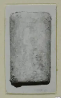 Blurred photograph of a rectangular find from Amathus, tombs 2-26, mounted on a cream card.