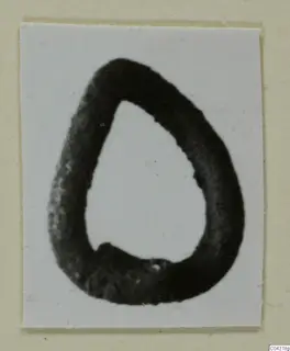 Teardrop-shaped loop find from Amathus, shown dark against a white background