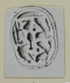 Glyptic from Amathus: an oval seal or scarab with dark incised markings, shown as a print on a card mount