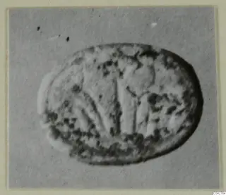 Oval glyptic object from Amathus with a worn carved design of upright and curving lines