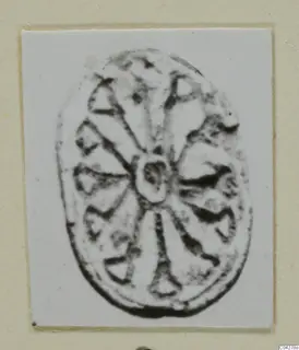 Oval engraved seal or gem from Amathus with a radiating pattern around a central boss.