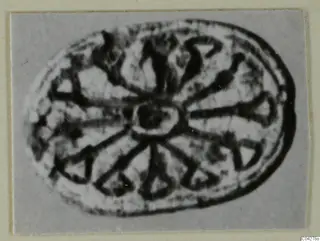 Oval seal or gem from Amathus with a central boss and dark radiating lines around it