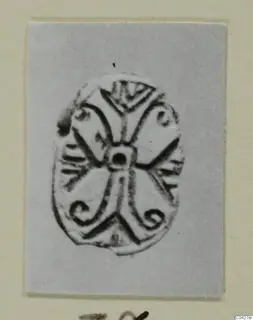 Oval glyptic seal with a pierced centre and spiral and chevron decoration