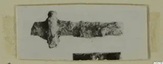 Corroded metal object from Amathus with a long bar and a short crosspiece near one end.