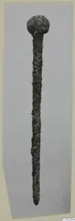 Corroded metal pin with a rounded head, from Amathus, shown on a grey card mount.