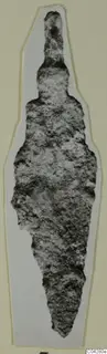 Corroded iron weapon blade from Amathus with a narrow tang at the top, cut out and mounted on white card