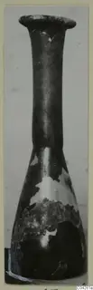 Dark narrow-necked vessel from Amathus with a flaring rim; surface flaking in places