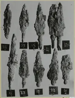 Ten corroded iron arrowheads and tanged points from Amathus, each beside a numbered tag.