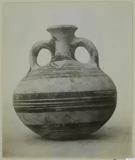 Round-bodied jar with two loop handles and a short flared neck, painted with horizontal dark bands.