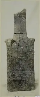 Grey idol from Lapithos with incised hatched bands and a broken top