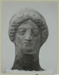 Terracotta head of a figurine with wavy hair and a neck, from the Marion tomb finds