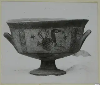 Painted pottery bowl on a tall foot, with a large bird and small cross-like motifs on its side