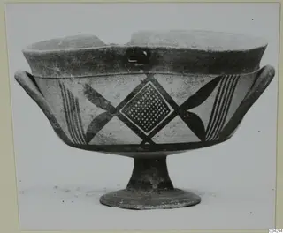 Footed pottery bowl with side handles, painted with dark bands, a diamond lattice panel and crossed motifs
