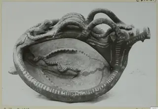 White Painted bowl with an animal-head spout and a painted snake inside