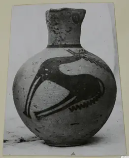 Painted jug, White Painted III-1, with a dark motif of a long curved neck and thin legs across its body