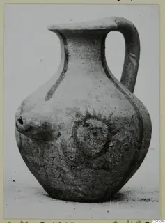 Pottery White Painted IV: a jug with a single loop handle, a short nozzle on the shoulder and a round applied motif on the body
